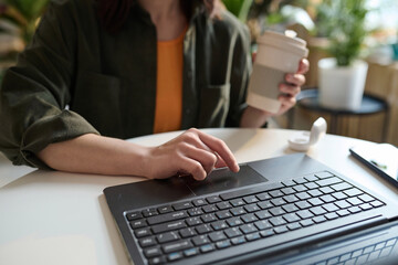 Fototapeta premium Hands of unrecognizable girl doing e-commerce on her laptop