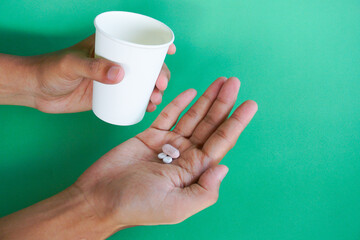 Sick, asian young man, boy hand holding pill capsule, painkiller medicine from stomach pain, head...