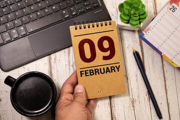 9 February on wooden grey cubes. Calendar cube date 09 February. Concept of date.