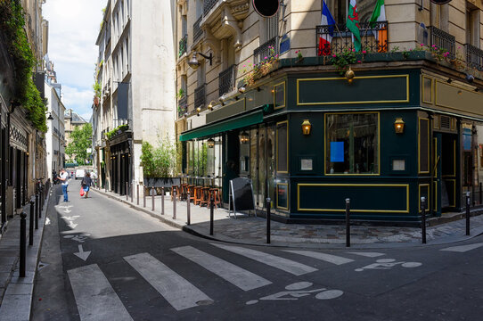 View of street with tables of cafe in Paris, France. Architecture and landmark of Paris. Cozy Paris cityscape