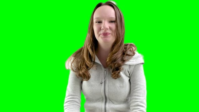 Caucasian attractive girl over white wall making unimportant gesture while lifting the shoulders wearing pastel shirt. High quality 4k footage