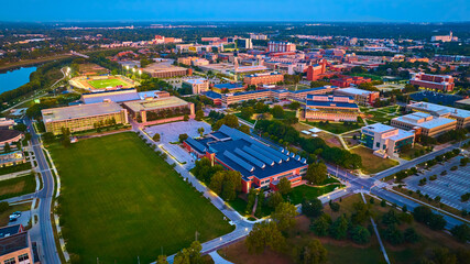 Aerial Twilight View of University Campus with Green Spaces and Modern Buildings - obrazy, fototapety, plakaty