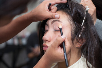 Fototapeta premium Photo of girl getting her eyebrows done in a spa. Concept of people and beauty.