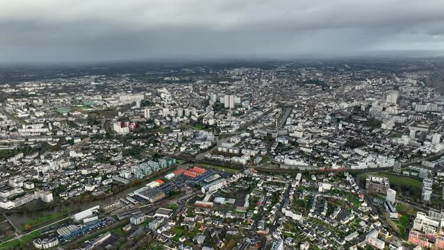 Vast city view of Rennes with dramatic clouds.