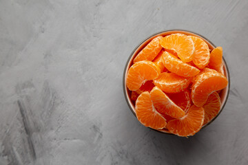 Organic Peeled Mandarin Oranges in a Bowl, top view. Copy space.