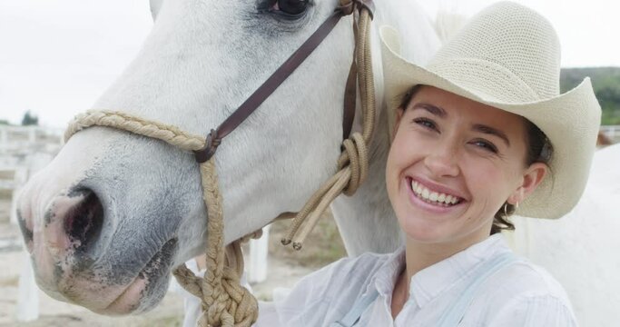 Woman, horse and pet care for horseback riding in texas, countryside and ready with cowboy hat. Face, stable and nature in outdoor, adventure and animal livestock with cowgirl, smile and farm girl