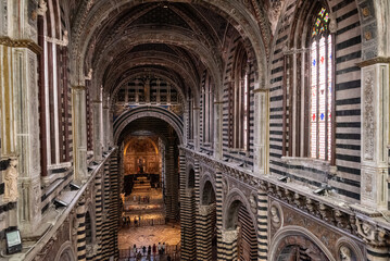 SIENA, ITALY - SEPTEMBER 23, 2023 - View to the nave of the cathedral in Siena, seen from the upper floor - obrazy, fototapety, plakaty