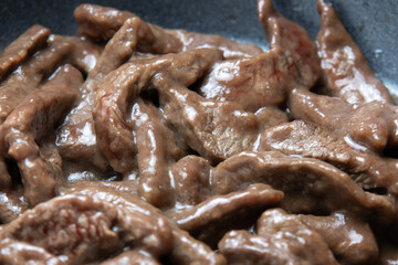 細切り牛肉(牛モモ肉)をフライパンで炒める。青椒肉絲(チンジャオロース)調理シーン。
