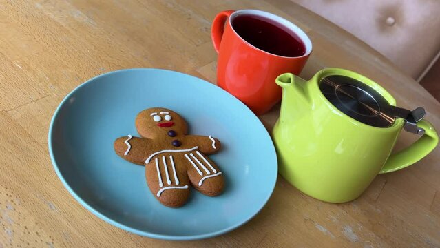 bright dishes pour red tea Hibiscus near the gingerbread man gift Christmas. delicious