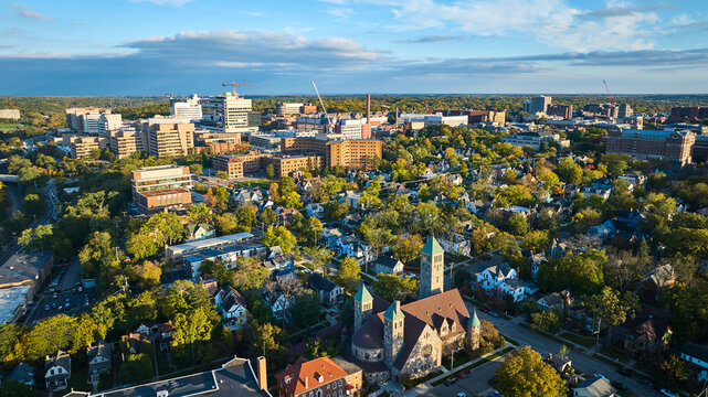 Aerial Golden Hour Over Historic Church and Urban Growth, Ann Arbor