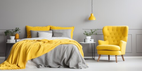 Bright bedroom with yellow vintage armchair, wardrobe, and grey and yellow bedding on bed with...