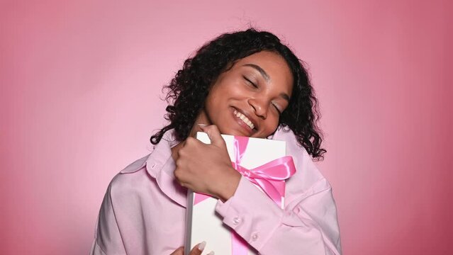 Valentines day,8 march,birthday concept. Studio footage with happy african american with gift box