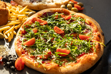 Crudo arugula pizza served in a restaurant