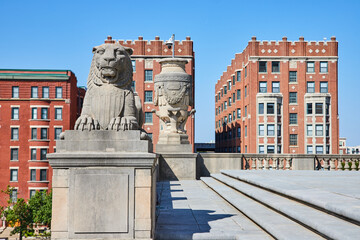 Majestic Lion Sculpture and Historic Architecture in Sunny Plaza