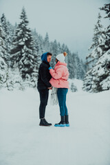 Fototapeta na wymiar On a snowy Valentine's Day, this romantic couple shares warmth, laughter, and tender embraces, creating a blissful winter love story.