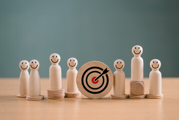 Business target and goal concept. Wooden figure dartboard and bullseye arrow for team marketing...