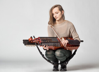 Musician perfects Scandinavian melodies on traditional nyckelhar
