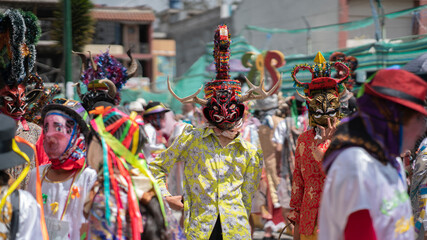 People with devil masks dancing at the Diablada Pillarena, a traditional festival of Ecuador - obrazy, fototapety, plakaty