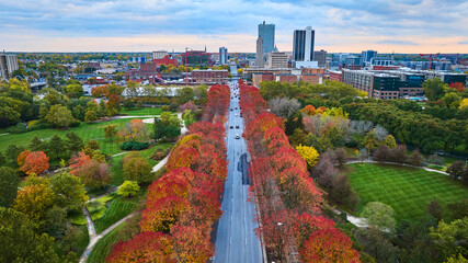 Aerial Autumn Urban Park and Cityscape at Sunrise