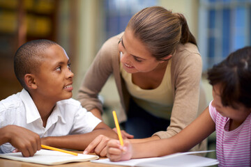 Happy teacher, students and writing in classroom for education, learning or tutoring at school....
