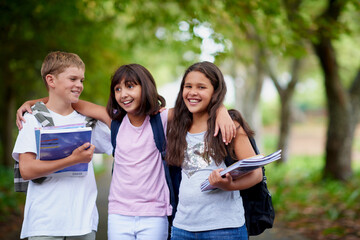 Happy kids, friends and hug with backpack in park for unity, teamwork or walking to school...