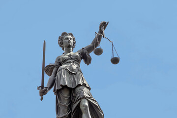 lady justice with sword in Frankfurt under blue sky