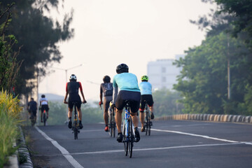a group of cyclists on the highway, cycling in groups to navigate urban areas while exercising...