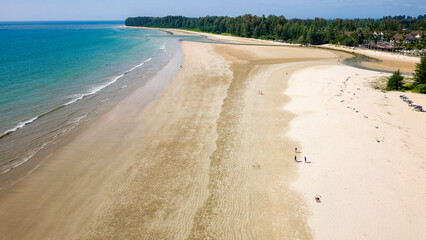 Drone view of a large, deserted tropical sandy beach and shallow, warm ocean (Memories Beach, Khao Lak, Thailand)
