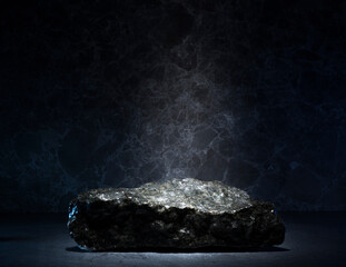 stones and ice for the podium. natural black stones in a thin layer of ice on a dark background for...