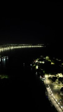 Imagem a&eacute;rea de drone da cidade de Guarapari a noite, praia do morro e prainha de muqui&ccedil;aba iluminadas. Decora&ccedil;&atilde;o de natal e festas de final de ano.