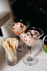 Elegant Chocolate Chip Mousse in Martini Glasses. Chocolate chip mousse served in stylish martini glasses, garnished with chocolate shavings, perfect for a sophisticated dessert offering.