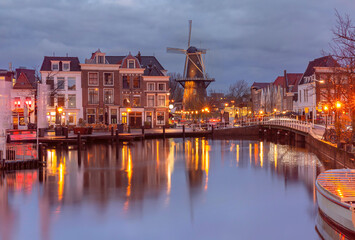 Night Leiden canal with Blauwpoortsbrug bridge and Windmill De Valk, South Holland, Netherlands