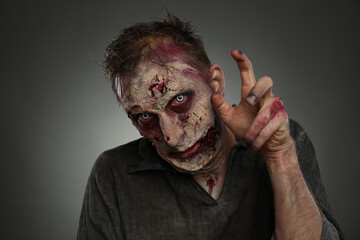 Scary zombie on dark background. Halloween monster