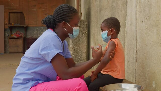 vaccine against virus injection in children of africa , medical treatment nurse doctor wearing mask 
