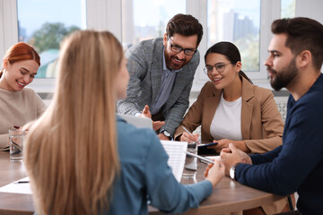 Team of employees working together in office