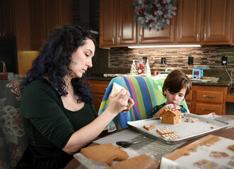 Fototapeta premium Mom and son make a gingerbread house