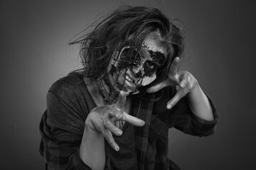 Scary zombie on dark background, black and white effect. Halloween monster