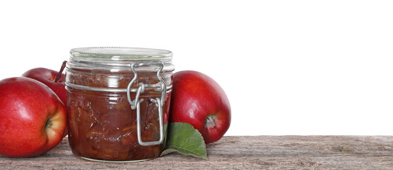 Delicious apple jam in jar and fresh fruits on wooden table against white background, space for text