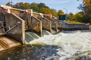 Autumnal Industrial Dam with Flowing Water, Eye-Level View