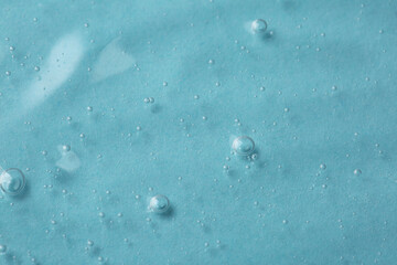 Cosmetic serum on light blue background, above view