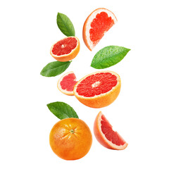 Fresh grapefruits and green leaves falling on white background