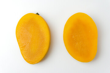 half cut juicy ripe mango isolated on white background, top view