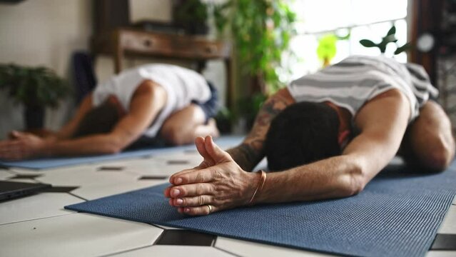 Men, friends and fitness with yoga and workout, childs pose for zen and wellness with body health and exercise together. Yogi team, pilates at home or house with mindfulness, stretching and active