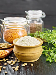 Flour lentil in bowl on dark wooden board