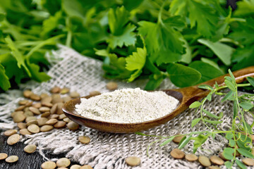 Flour lentil in spoon on board