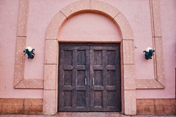 Fototapeta na wymiar Vintage Wooden Door with Ornamental Lights, Rustic Charm