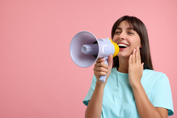 Special promotion. Woman shouting in megaphone on pink background, space for text