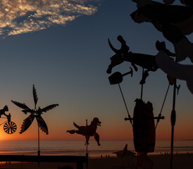 Metal Animal Spinners Silhouettes in Front of Colorful Huntington Beach Sunset, California, USA,...