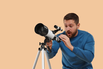 Excited astronomer with telescope on beige background. Space for text