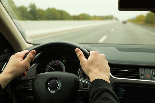 Man driving his car, closeup. Traffic rules